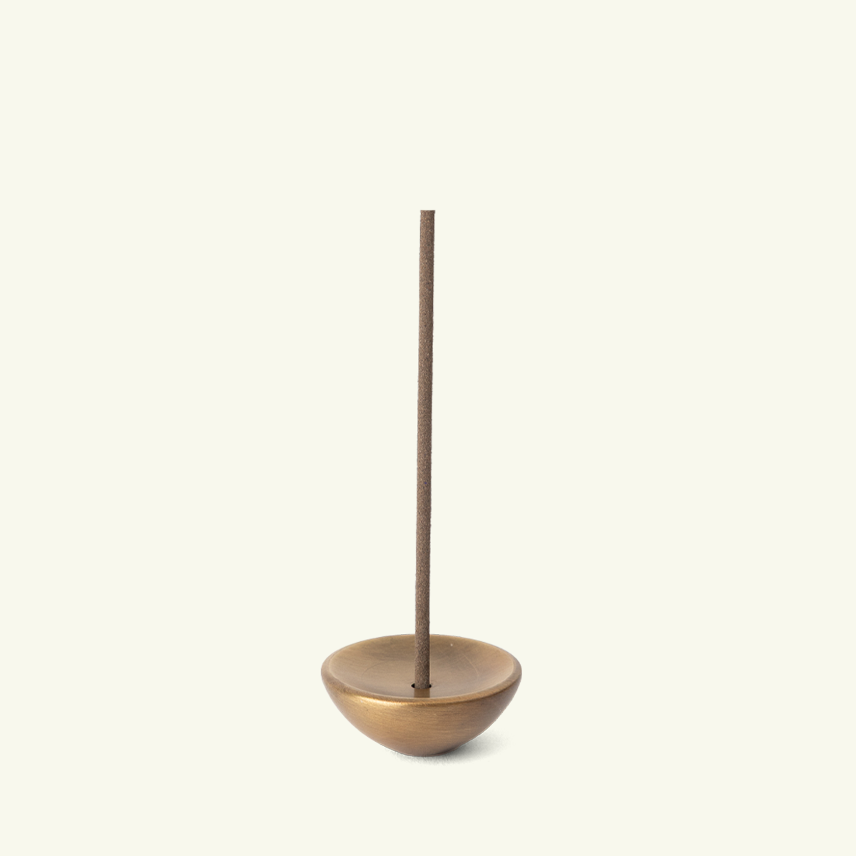 Kubo brass incense holder with a warm golden finish